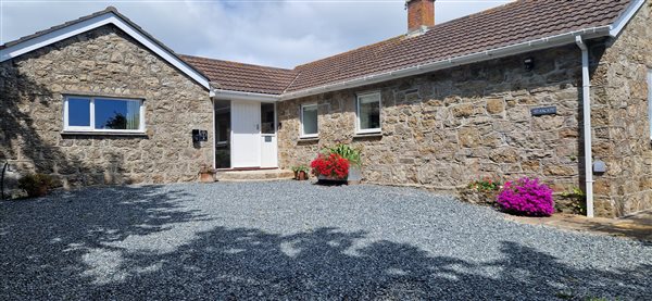 cottage with flowers and ev charger