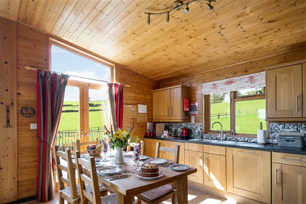 Hipley kitchen with double doors on to decking 