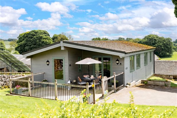 outside of Rainster log cabin at Hoe Grange Holidays 