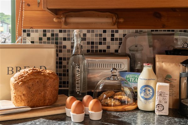 welcome pack with bread, eggs, milk, butter, biscuits and eggs 