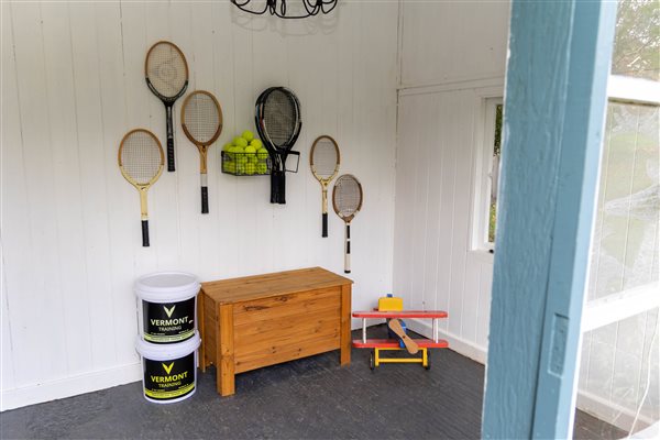 Tennis court with rackets and ball available