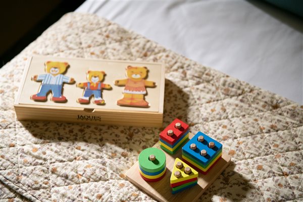 Wooden toys on a child's bed