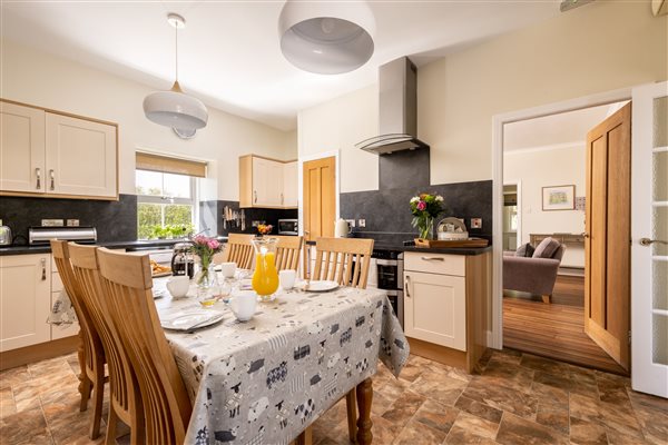 Kitchen with farmhouse table, light through window