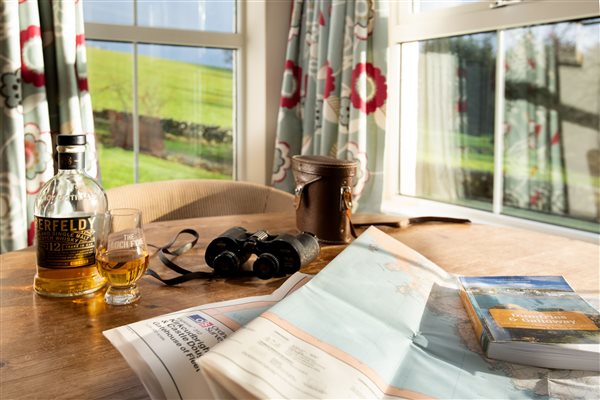 Bay window with table, maps and binoculars