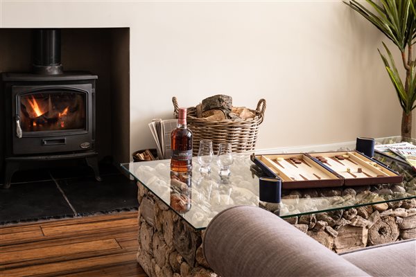 Wood burner with fire lit, coffee table with backgammon