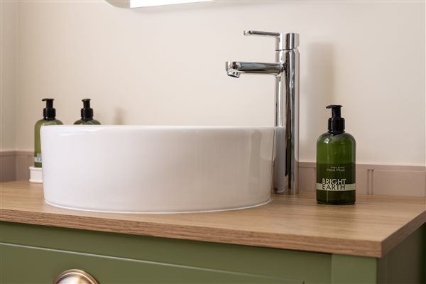 Close up of shower room basin with ecological toiletries