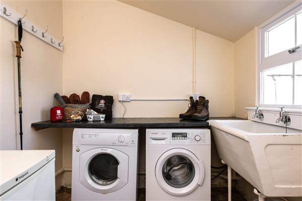 Utility room with large sink, washing machine, tumble dryer, surfaces