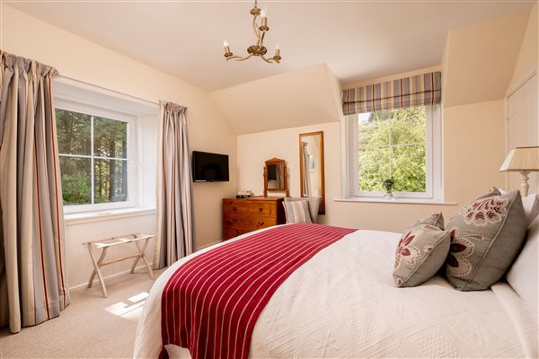 King bedded room with two windows and views over the sea and garden