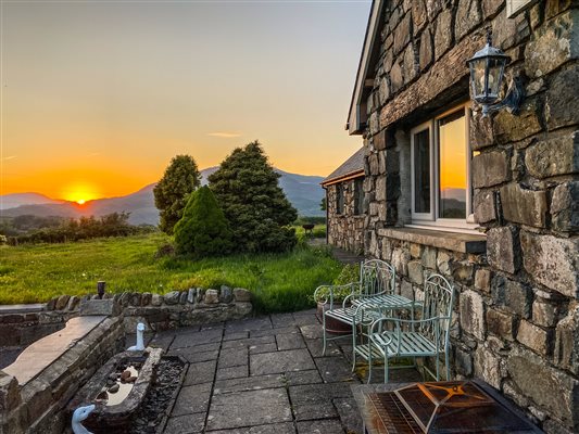 sunset with mountain views from cottage at Snowdonia Holidays Tyddyn Du Farm Eryri North Wales